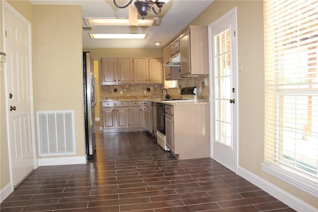 2501 Windchase Dr, Flower Mound, TX 75028 - kitchen with electric stove, under cabinet range hood, backsplash, and dark wood-style flooring