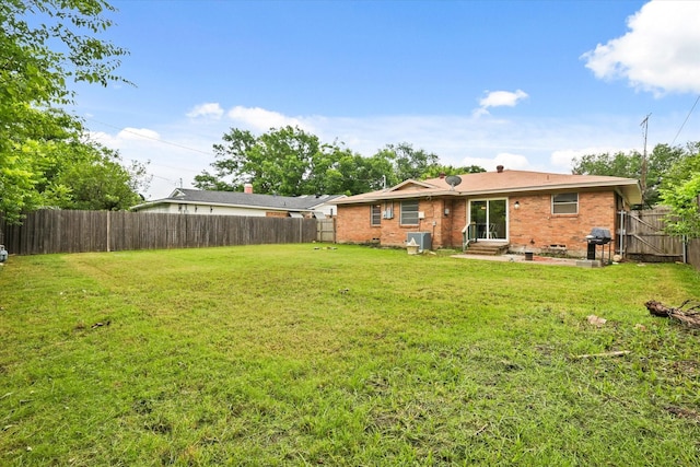 1716 Cordell St, Denton, TX 76201 - back of house with a fenced backyard, brick siding, and entry steps