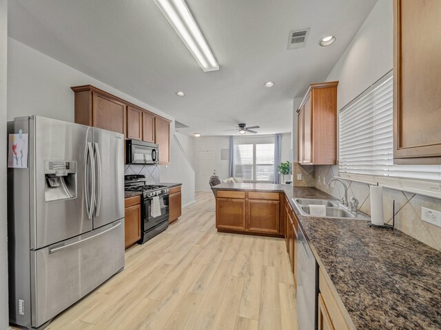2021 Prospect Ln, Providence Village, TX 76227 - kitchen with black appliances, light wood finished floors, backsplash, ceiling fan, and brown cabinetry