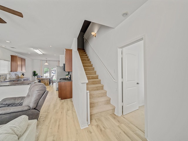 2021 Prospect Ln, Providence Village, TX 76227 - living room featuring stairs, light wood-style floors, recessed lighting, and a ceiling fan