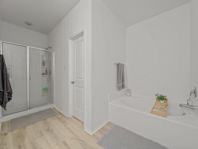 2021 Prospect Ln, Providence Village, TX 76227 - bathroom featuring a bath, a shower stall, and wood finished floors