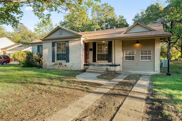 82 Vaughn Dr, Denison, TX 75020 - view of front of home with brick siding, a porch, and a front yard