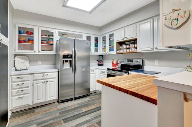 3003 Rustling Leaves Ln, Bedford, TX 76021 - kitchen featuring stainless steel appliances, light wood-type flooring, glass insert cabinets, white cabinetry, and butcher block counters