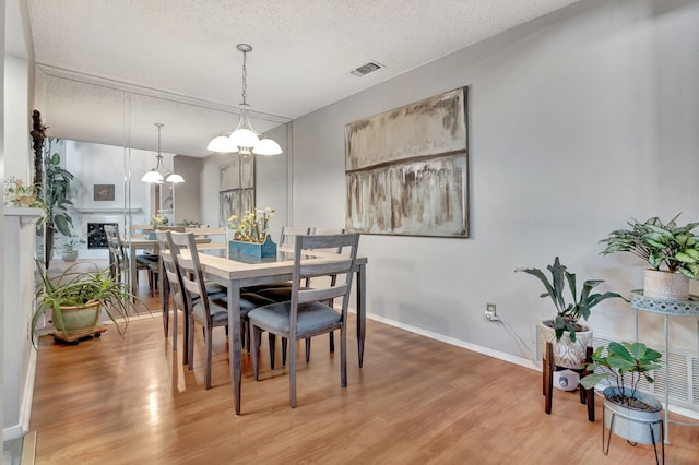3003 Rustling Leaves Ln, Bedford, TX 76021 - dining room with light wood-style floors and a textured ceiling