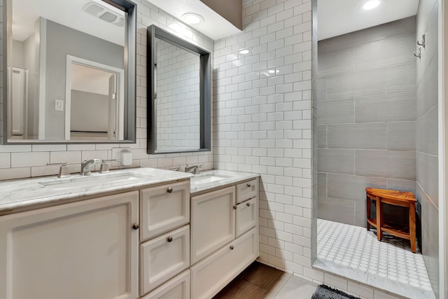 3003 Rustling Leaves Ln, Bedford, TX 76021 - bathroom featuring tile walls, double vanity, and walk in shower