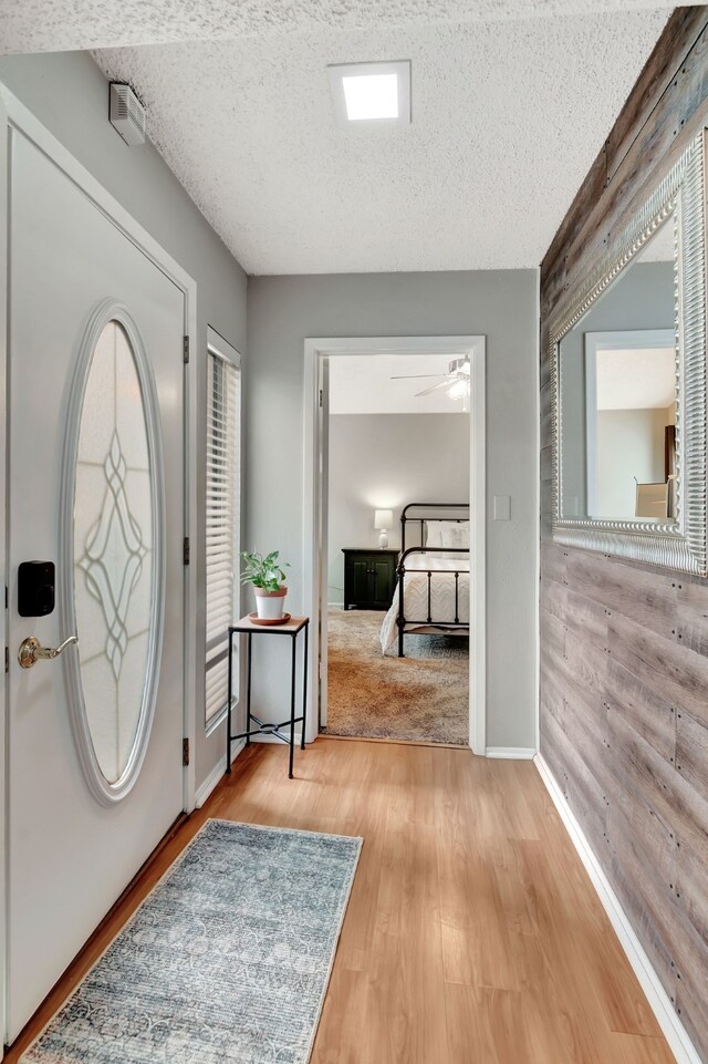 3003 Rustling Leaves Ln, Bedford, TX 76021 - entrance foyer with wood finished floors, ceiling fan, and a textured ceiling