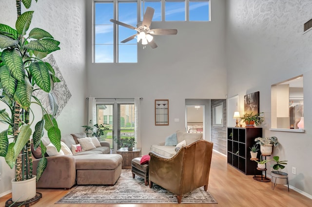 3003 Rustling Leaves Ln, Bedford, TX 76021 - living area with a high ceiling, a ceiling fan, light wood-style floors, and plenty of natural light