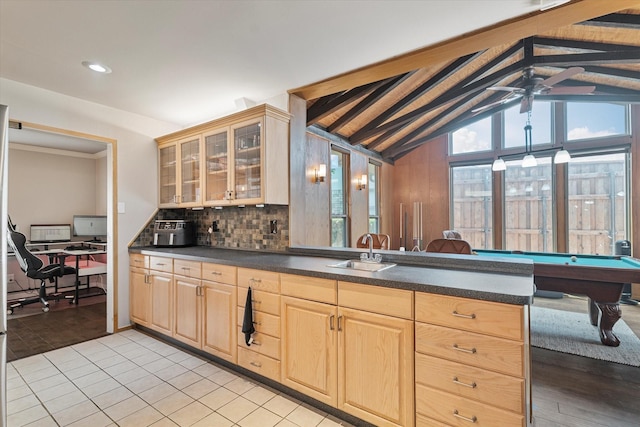 4043 Star Trek Ln, Garland, TX 75044 - kitchen with light brown cabinetry, dark countertops, a ceiling fan, decorative backsplash, and glass insert cabinets