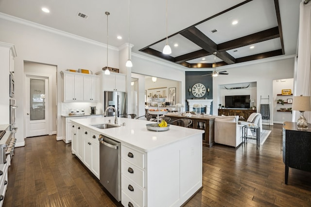 6603 Erin Ln, Parker, TX 75002 - kitchen with appliances with stainless steel finishes, a ceiling fan, a fireplace, light countertops, and ornamental molding