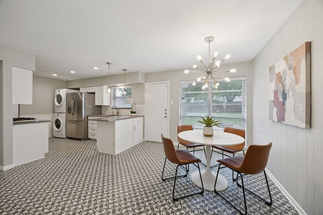 11335 Fernald Ave, Dallas, TX 75218 - dining space with stacked washer / drying machine, a chandelier, and recessed lighting