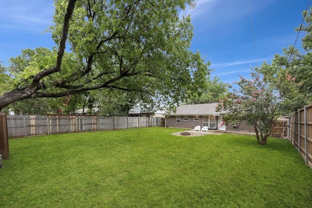 11335 Fernald Ave, Dallas, TX 75218 - fenced backyard featuring an outdoor fire pit and a patio area