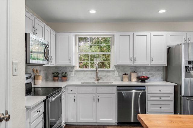 102 Collin Ct, Prosper, TX 75078 - kitchen with appliances with stainless steel finishes, backsplash, white cabinetry, recessed lighting, and wooden counters