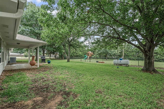 102 Collin Ct, Prosper, TX 75078 - fenced backyard with a playground, view of wooded area, and a patio