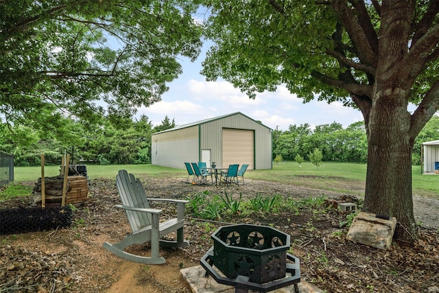 102 Collin Ct, Prosper, TX 75078 - view of green lawn featuring a detached garage and an outbuilding