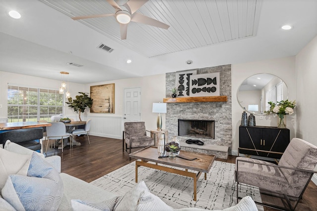 102 Collin Ct, Prosper, TX 75078 - living room with wood finished floors, a stone fireplace, ceiling fan, a wainscoted wall, and recessed lighting