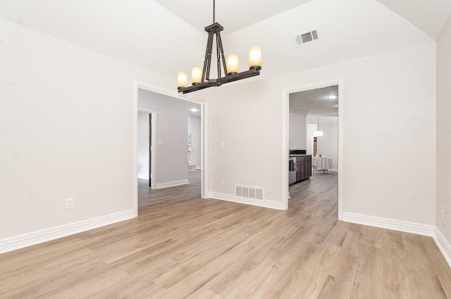 4410 Briargrove Ln, Dallas, TX 75287 - unfurnished room featuring light wood finished floors and a chandelier