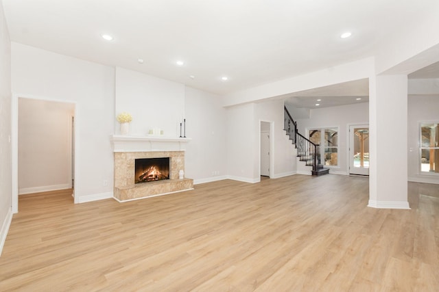 4410 Briargrove Ln, Dallas, TX 75287 - unfurnished living room featuring stairs, recessed lighting, light wood-style floors, and a fireplace