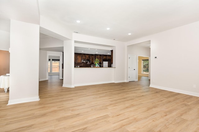 4410 Briargrove Ln, Dallas, TX 75287 - unfurnished living room with light wood-style flooring and recessed lighting