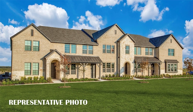 736 4th St, Argyle, TX 76226 - view of front of house featuring a standing seam roof, a front yard, stone siding, and brick siding