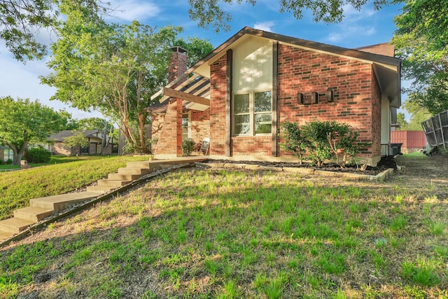 1024 E Peters Colony Rd, Carrollton, TX 75007 - view of home's exterior featuring a chimney and brick siding