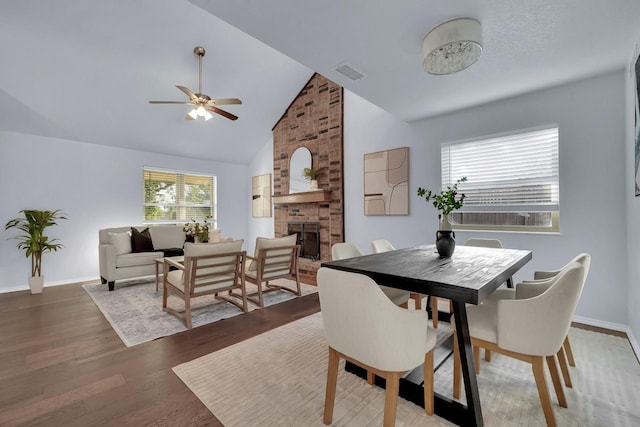 1024 E Peters Colony Rd, Carrollton, TX 75007 - dining room with a fireplace, a ceiling fan, wood finished floors, and high vaulted ceiling