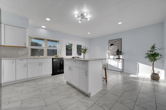 1024 E Peters Colony Rd, Carrollton, TX 75007 - kitchen with black dishwasher, light countertops, a center island, white cabinetry, and recessed lighting