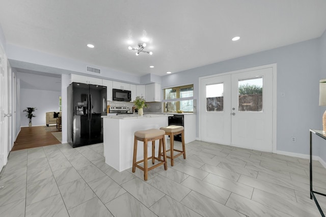 1024 E Peters Colony Rd, Carrollton, TX 75007 - kitchen featuring black appliances, light marble finish floors, light countertops, and recessed lighting