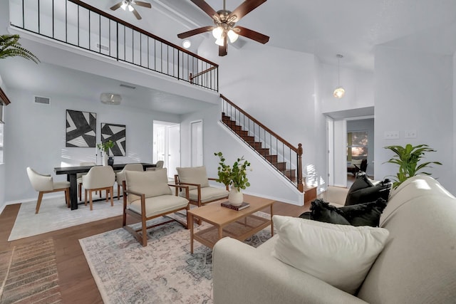 1024 E Peters Colony Rd, Carrollton, TX 75007 - living room with a ceiling fan, stairs, a high ceiling, and dark wood-style floors