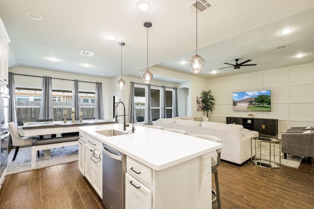 8116 Charford Dr, Fort Worth, TX 76131 - kitchen with stainless steel dishwasher, open floor plan, dark wood-style flooring, ceiling fan, and white cabinetry