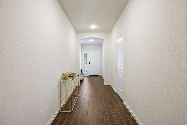 8116 Charford Dr, Fort Worth, TX 76131 - corridor with arched walkways, dark wood finished floors, and a textured wall