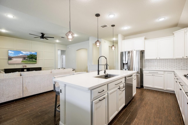 8116 Charford Dr, Fort Worth, TX 76131 - kitchen featuring open floor plan, arched walkways, stainless steel appliances, dark wood-type flooring, and a ceiling fan