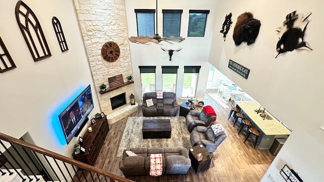 1518 Primrose Pl, Haslet, TX 76052 - living area with a towering ceiling, wood finished floors, and a stone fireplace
