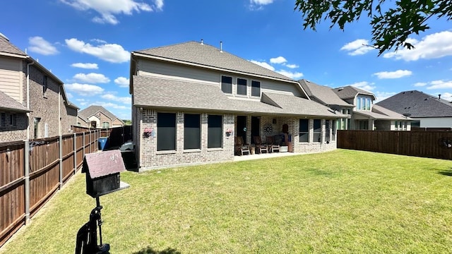 1518 Primrose Pl, Haslet, TX 76052 - back of property featuring brick siding, a patio area, a fenced backyard, and roof with shingles