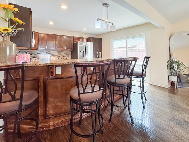 503 White Oak St, Allen, TX 75002 - bar area featuring stainless steel fridge, dark wood-type flooring, decorative backsplash, recessed lighting, and pendant lighting