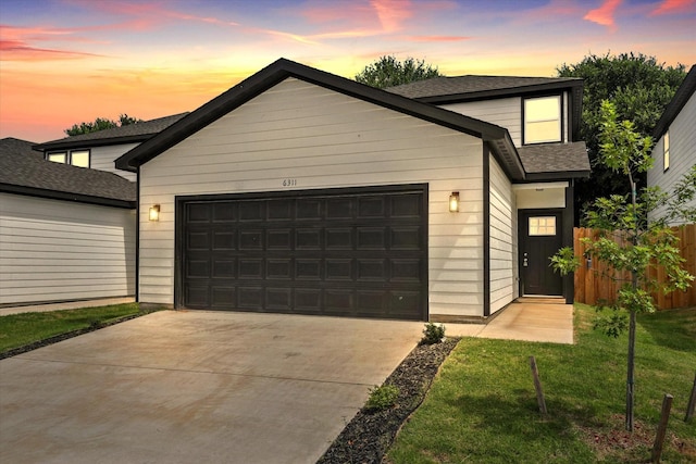 6311 Pebble Ave, Dallas, TX 75217 - view of front of property with an attached garage, concrete driveway, and a shingled roof