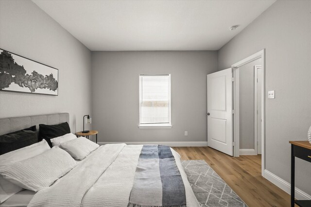 6311 Pebble Ave, Dallas, TX 75217 - bedroom with light wood finished floors and baseboards