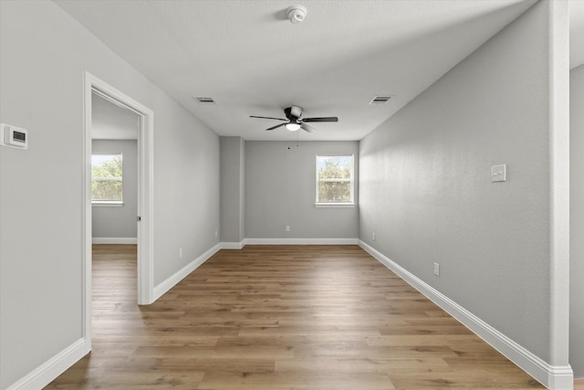 6311 Pebble Ave, Dallas, TX 75217 - spare room featuring a smoke detector, ceiling fan, plenty of natural light, and light wood-type flooring