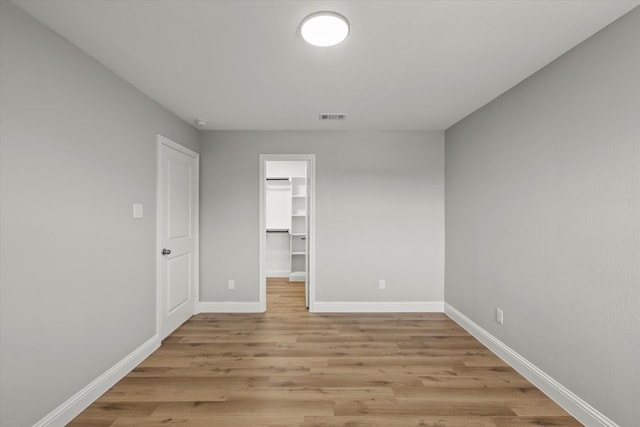 6311 Pebble Ave, Dallas, TX 75217 - unfurnished room with baseboards and light wood finished floors
