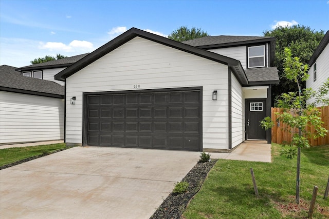 6311 Pebble Ave, Dallas, TX 75217 - view of front of property featuring a garage, concrete driveway, and a shingled roof