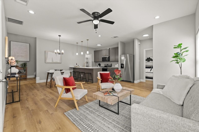 6311 Pebble Ave, Dallas, TX 75217 - living area with ceiling fan, a chandelier, light wood-style floors, and recessed lighting