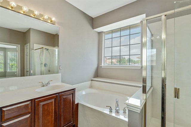 3212 Cantura Dr, Mesquite, TX 75181 - full bath with healthy amount of natural light, vanity, a garden tub, and a stall shower