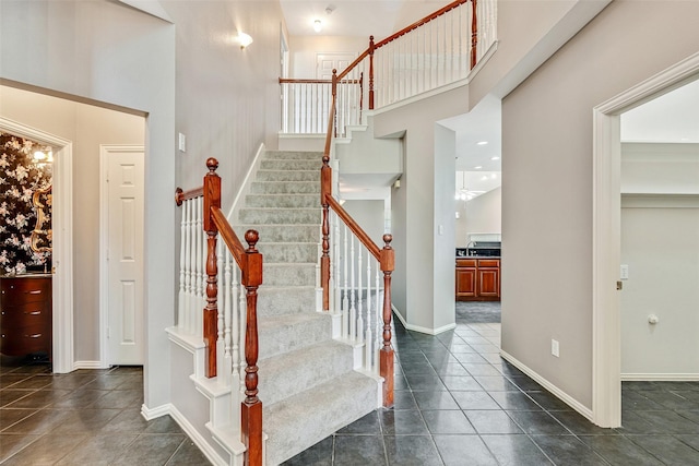 3212 Cantura Dr, Mesquite, TX 75181 - staircase with tile patterned floors and a towering ceiling