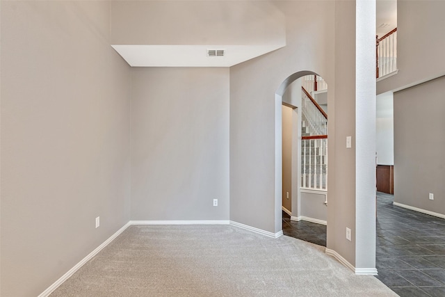 3212 Cantura Dr, Mesquite, TX 75181 - spare room with arched walkways, dark carpet, and stairway
