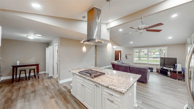 2305 Briarwood Ln, Carrollton, TX 75006 - kitchen with island exhaust hood, ceiling fan, stainless steel appliances, open floor plan, and a kitchen island