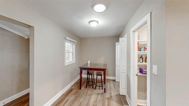 2305 Briarwood Ln, Carrollton, TX 75006 - dining room featuring wood finished floors and a textured ceiling