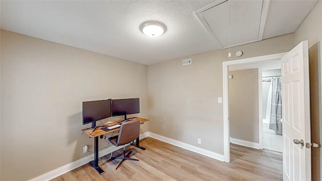 2305 Briarwood Ln, Carrollton, TX 75006 - office space featuring attic access, light wood finished floors, and a textured ceiling