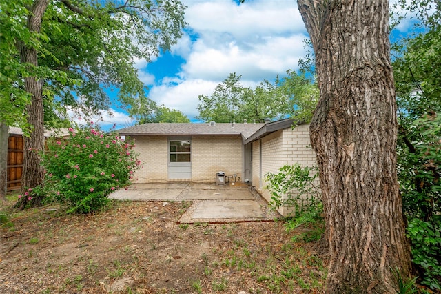 2305 Briarwood Ln, Carrollton, TX 75006 - back of property featuring a patio area and brick siding