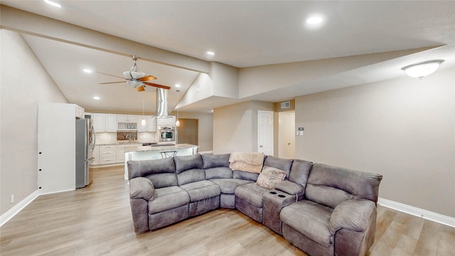 2305 Briarwood Ln, Carrollton, TX 75006 - living room with vaulted ceiling, light wood-style floors, a ceiling fan, and recessed lighting