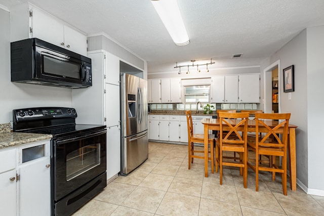 567 Peavy Rd, Dallas, TX 75218 - kitchen featuring black appliances, white cabinets, a textured ceiling, and light tile patterned floors