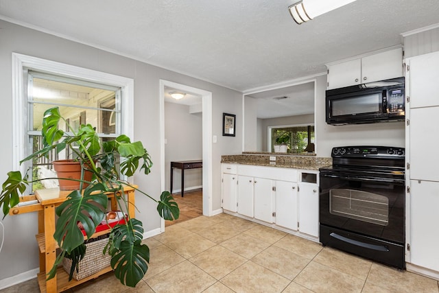 567 Peavy Rd, Dallas, TX 75218 - kitchen featuring black appliances, white cabinetry, light tile patterned floors, and ornamental molding